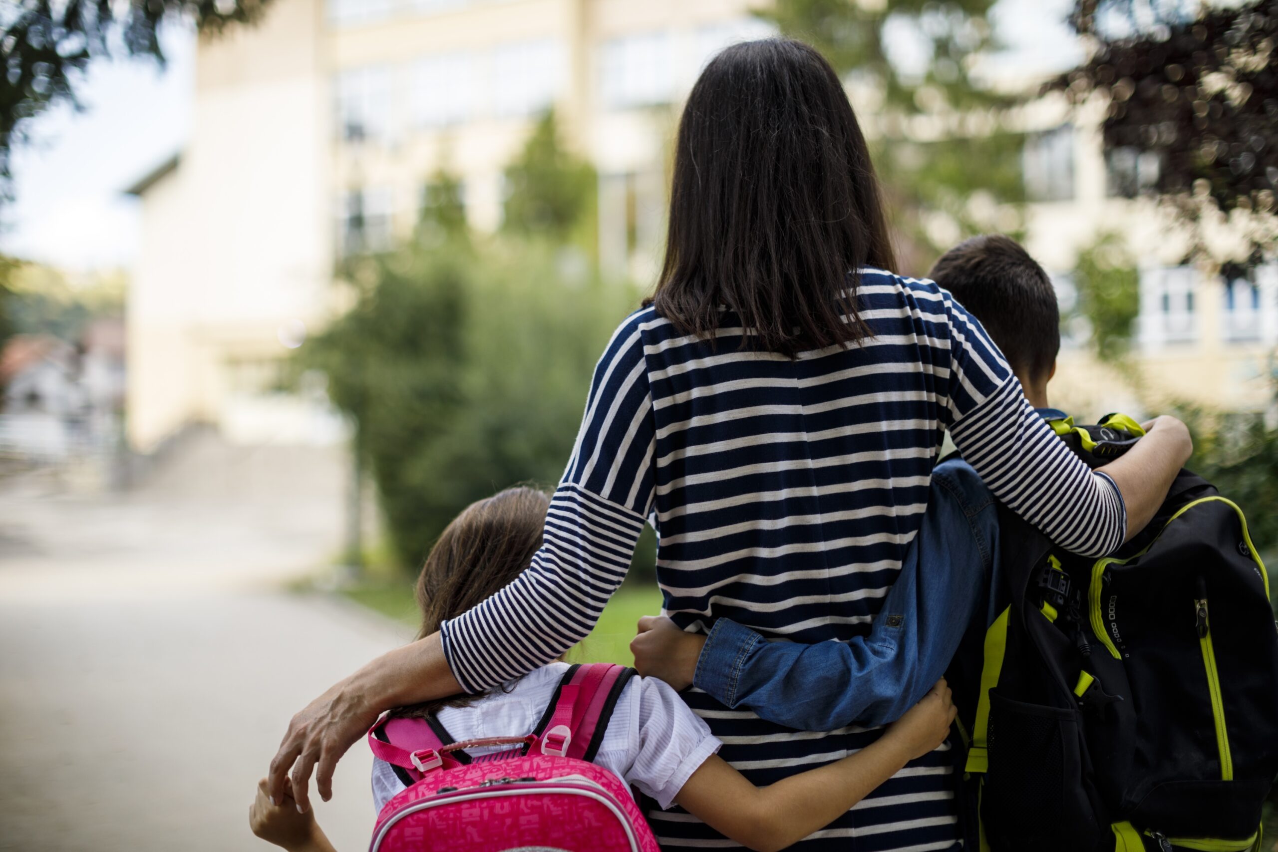 Mother taking kids to school